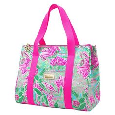 a pink and green floral print bag on a white background with fuchsia handles