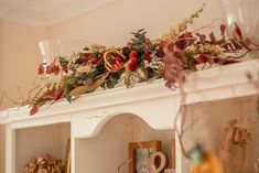 a mantle with flowers and candles on it