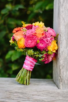 a bouquet of flowers sitting on top of a wooden bench