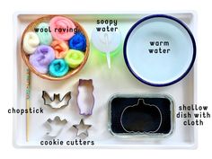 a tray with cookie cutters, bowls and other items