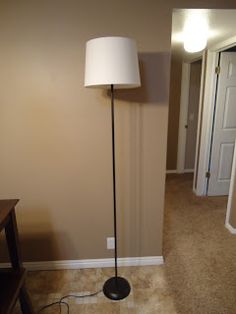 a floor lamp in the corner of a room