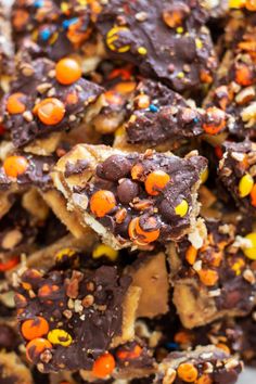 a pile of halloween brownies with candy and sprinkles on top is shown