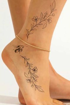 a woman's foot with flowers and leaves tattoo on the side of her leg