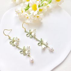 🍀 Size: 7.3x1.4 cm 🍀 Material: Freshwater Pearl, 14K Gold Plated Sterling Silver Hook, Brass (✨Hypoallergenic Hook✨) Description 🌸 Add a touch of delicate elegance to your look with these extremely intricate and delicate Lily of the Valley earrings. These ethereal dangle earrings feature freshwater pearls and the iconic bell-shaped blooms of the Lily of the Valley flower, creating a romantic and sophisticated look. Each flower is flexibly attached to the stem, creating a lifelike vivid look.  These earrings are perfect for brides-to-be or as a special gift for your bridesmaids. They also make for a great addition to any formal or special occasion outfit. Please note that freshwater pearls are naturally unique and may exhibit slight variations in size, shape, and colour. 🌸 ⭐️ Shop more Earrings Cottagecore, Cottagecore Earrings, Silver Bridal Earrings, Lily Of The Valley Flowers, Valley Flowers, Bridal Earrings Drop, Freshwater Pearl Earrings, Earrings Bridesmaid, Special Occasion Outfits