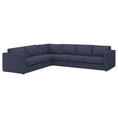 a large blue sectional couch sitting on top of a white floor