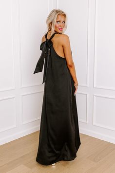 - Perfect for a date night in paradise, this gorgeous maxi is a must-have! - Satin finished material - A built-in lining ending above the knee - A v-cut neckline with a halter tied back with a keyhole detail - A flowy silhouette that ends in a maxi length hemline Evening Black Maxi Dress With Tie Back, Tie Back Maxi Length Halter Dress For Brunch, Backless Maxi Dress For Black-tie Events, Sleeveless Satin Maxi Dress For Vacation, Maxi Length Halter Dress With Tie Back For Brunch, Black Halter Neck Maxi Dress With Tie Back, Beach Halter Neck Satin Maxi Dress, Black Halter Maxi Dress For Night Out, Elegant Beach Maxi Dress With Tie Back