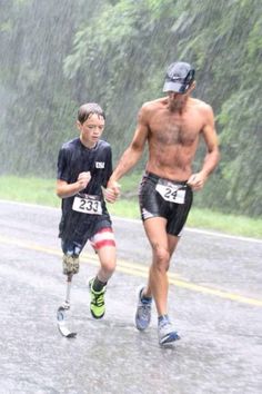 two men running in the rain with no shirts on