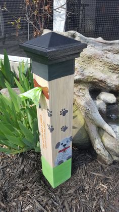 a wooden post with a dog design on it