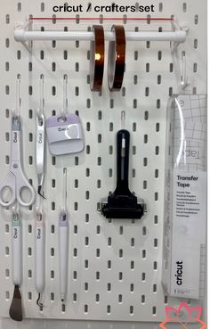 there are many different items on the pegboard with scissors, tape and other things