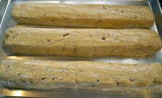 three long pieces of bread sitting on top of a metal pan