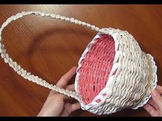 someone is making a basket out of woven material