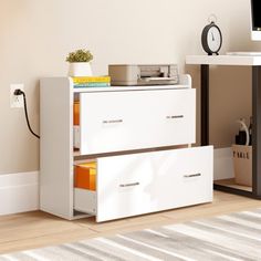 a white dresser with two drawers and a clock on top