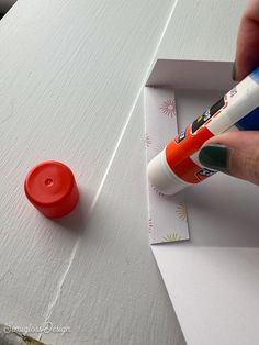 someone is painting the side of a white table