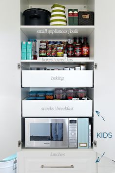 an organized kitchen pantry with white cabinets and shelves filled with food, containers and utensils