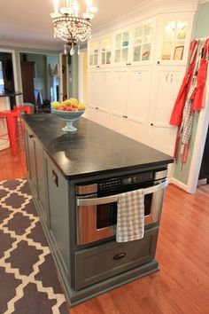 a kitchen island with an oven and dishwasher