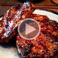 two steaks covered in bbq sauce on a plate