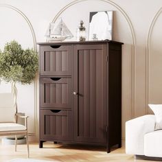 a living room with a white couch and brown cabinet in the corner next to a chair