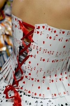 a woman in a dress made out of playing cards