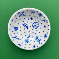 a blue and white bowl sitting on top of a green table