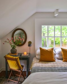 a bedroom with a bed, desk and mirror