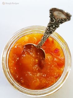 a spoon in a glass jar filled with food