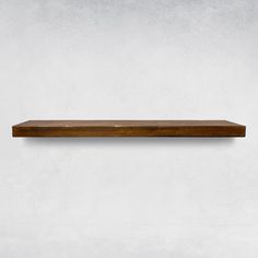 a wooden shelf mounted on the wall