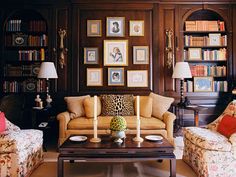 a living room filled with furniture and bookshelves covered in lots of bookcases