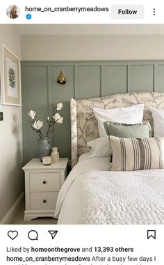 a white bed sitting in a bedroom on top of a wooden floor next to a wall