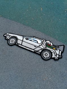 a drawing of a race car on the ground