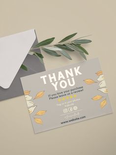 a thank card with leaves on it next to an envelope that says, thank you