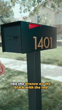 a mailbox with the words, i like the bronze on the black with the red