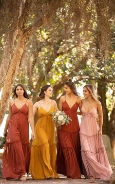 the bridesmaids are wearing different colored dresses