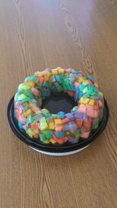 a cake made to look like a candy ring on top of a black platter