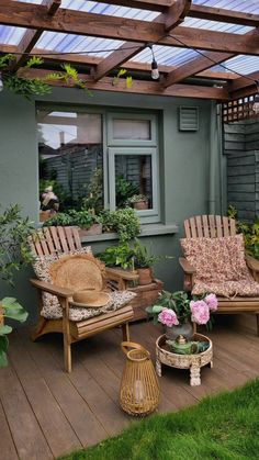 an outdoor patio with wooden furniture and potted plants on the decking area,