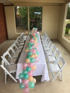 a long table with many balloons on it