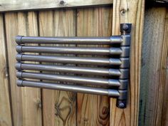 an old metal radiator on a wooden fence