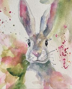 a watercolor painting of a rabbit with flowers in front of it's face