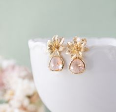 "These are stunning peach champagne glass jewels and gold flowers post earrings. Sparkly glass jewels are faceted and gold framed. Flowers are matte gold plated over brass with sterling silver ear posts that are great for sensitive ears. These earrings are perfect for a romantic night out or a gold and cobalt blue themed wedding. Total length: approx. 1.2\" (29mm) Peach glass jewels: 13mm x 15mm ♥ Click the link below to see more beautiful modern earrings: www.etsy.com/shop/LeChaim?section_id=17 Elegant Apricot Jewelry For Wedding, Framed Flowers, Blue Themed Wedding, Wedding Gifts For Bridesmaids, Romantic Night, Peach Wedding, Etsy Bridesmaid Gifts, Vintage Inspired Wedding, Flower Stud