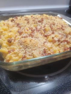 a casserole dish with meat and cheese in it on top of the stove