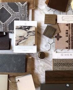 some different types of tile on a table with papers and magnets next to them