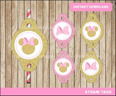 some pink and gold minnie mouse tags on a wooden surface with candy canes in the foreground