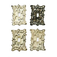 three decorative switch plates with ornate designs on them