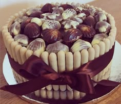 there is a cake that has chocolates on the top and shells on the bottom