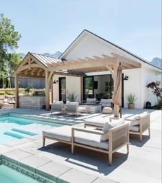 an outdoor living area next to a swimming pool