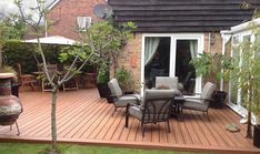 a patio with chairs, table and an umbrella