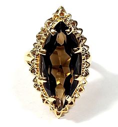 5 Carat Smokey Quartz 14k Yellow Gold Marquise Shaped Vintage Ring.  It's in excellent condition with minimal wear. It looks new when worn and from the top. The quartz has a deep brown color. It weighs 8.4 grams. The top section of the ring measures about 28 by 15mm. The topaz is approximately 5.4 carats.  Such a beautiful ring!  Pv2437. Deep Brown, Beautiful Ring, Smokey Quartz, Vintage Ring, Brown Color, Vintage Rings, Beautiful Rings, Topaz, Gemstone Rings