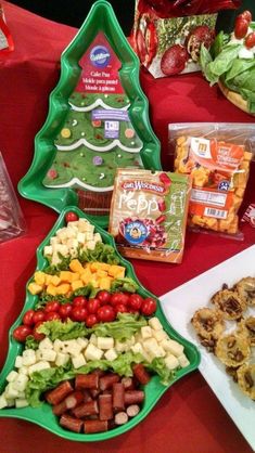 christmas tree shaped food trays on a table with other foods and snacks in the background