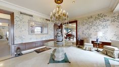 an elegant living room with chandelier and white furniture