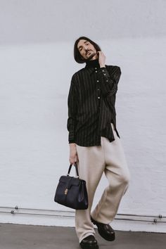 Studio Shoot of a man with long hair and a beard. Wearing a striped shirt, beigs pants and a handbag. Striped Shirt, A Man, Long Hair, Berlin