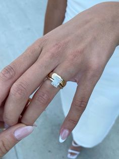 a close up of a person's hand with a ring on it